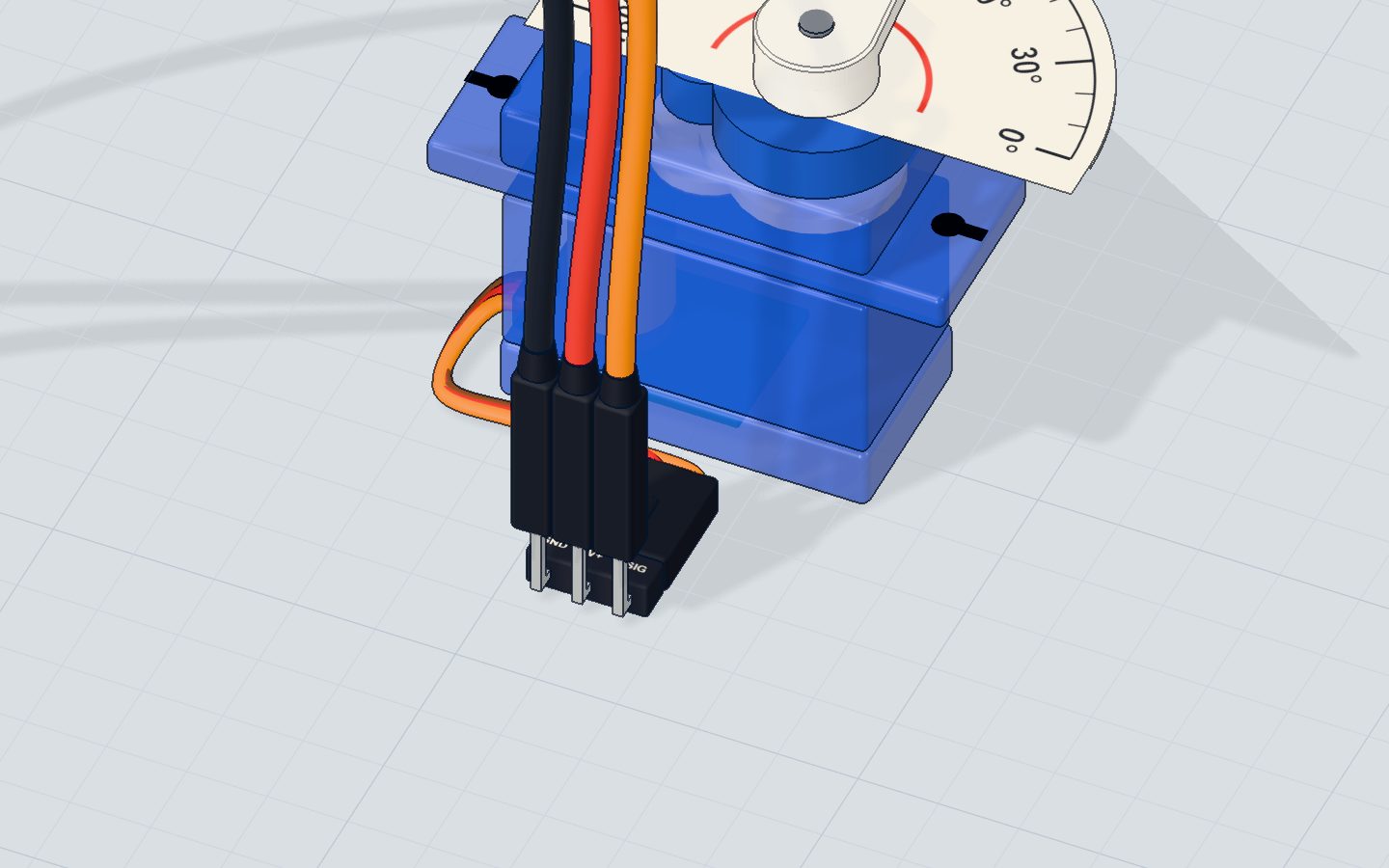 Close-up of the SG90 servo with its white horn and three-wire lead